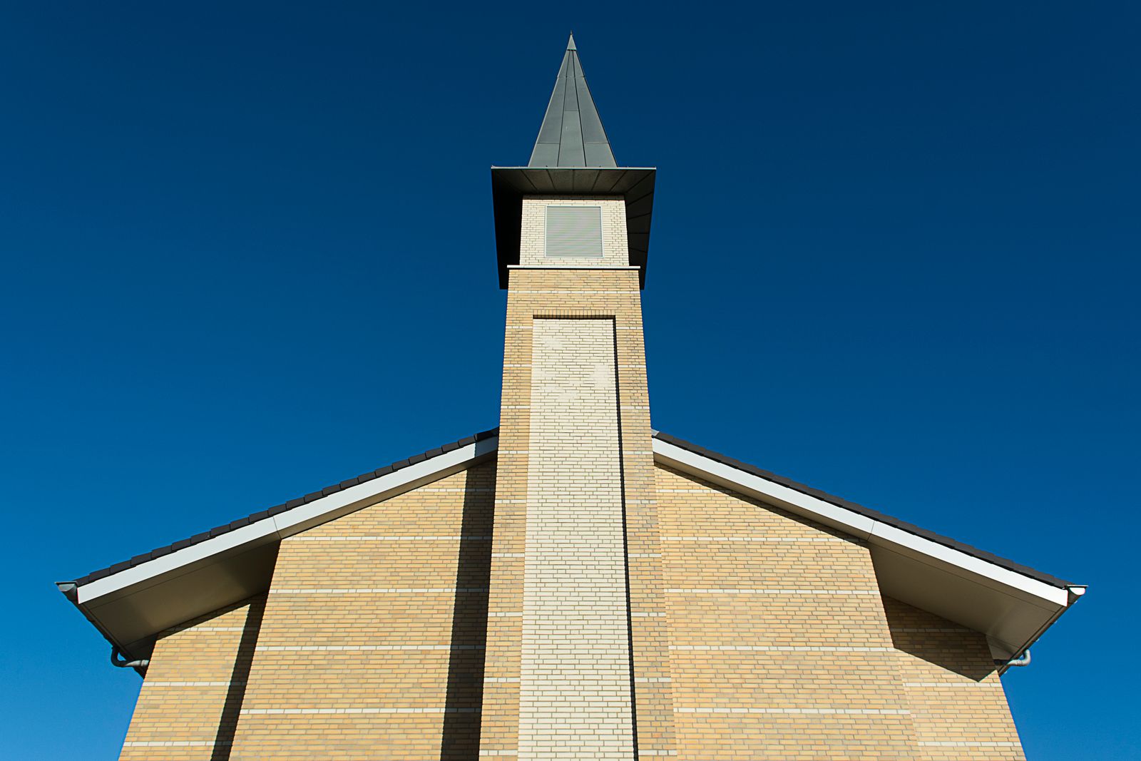 Brick commercial building with a steeple, representative of Robinson Inc's church and commercial construction work